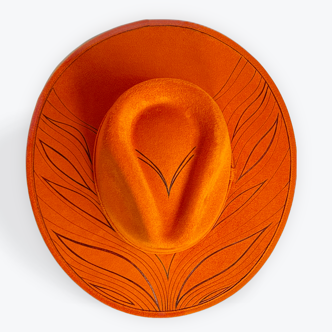 Rust orange hat with wave designs on a white background