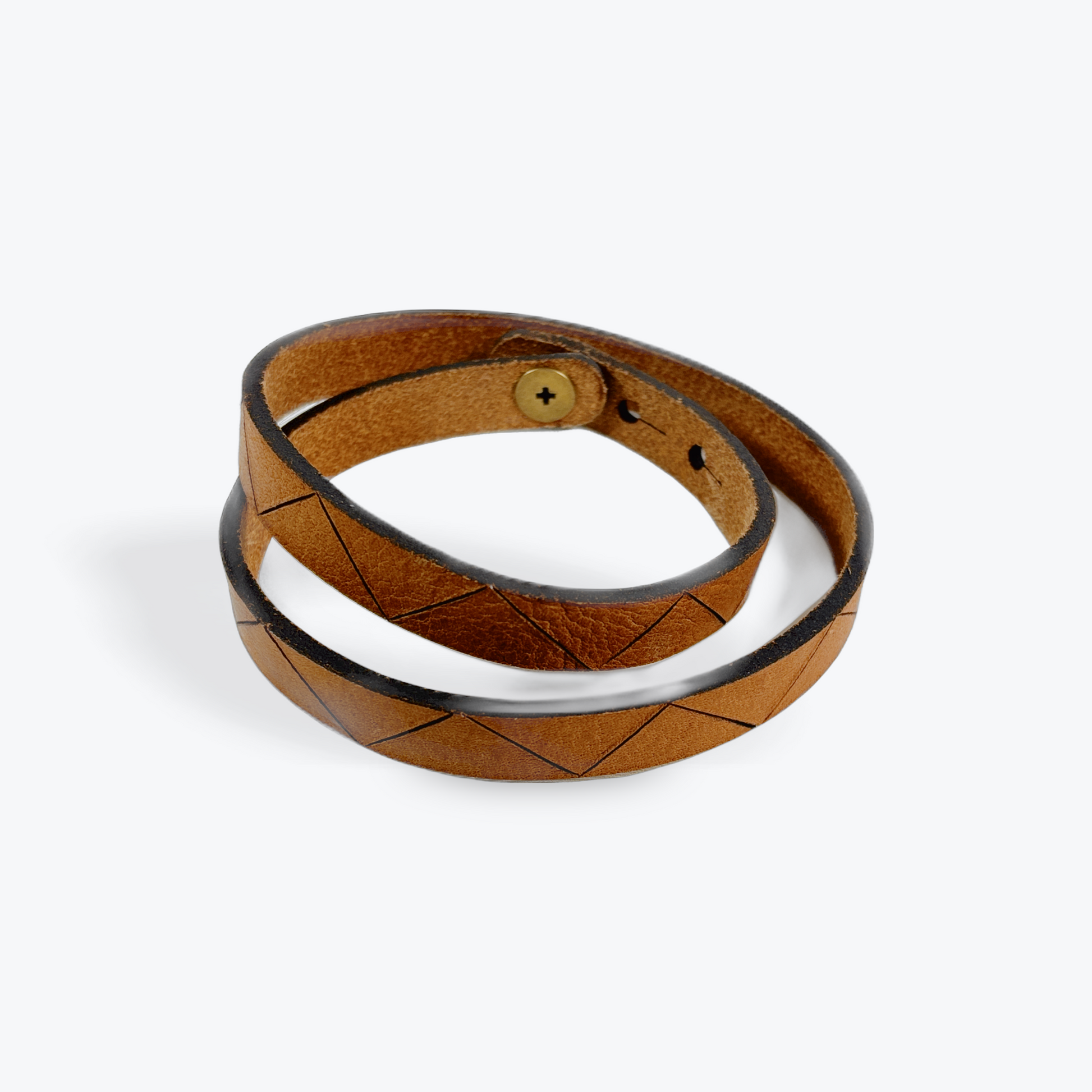 Brown leather wood-burned pyrography bracelet with a white interior on a white background
