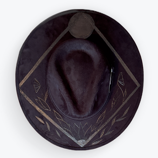 Black leather hat with geometric patterns on a white background