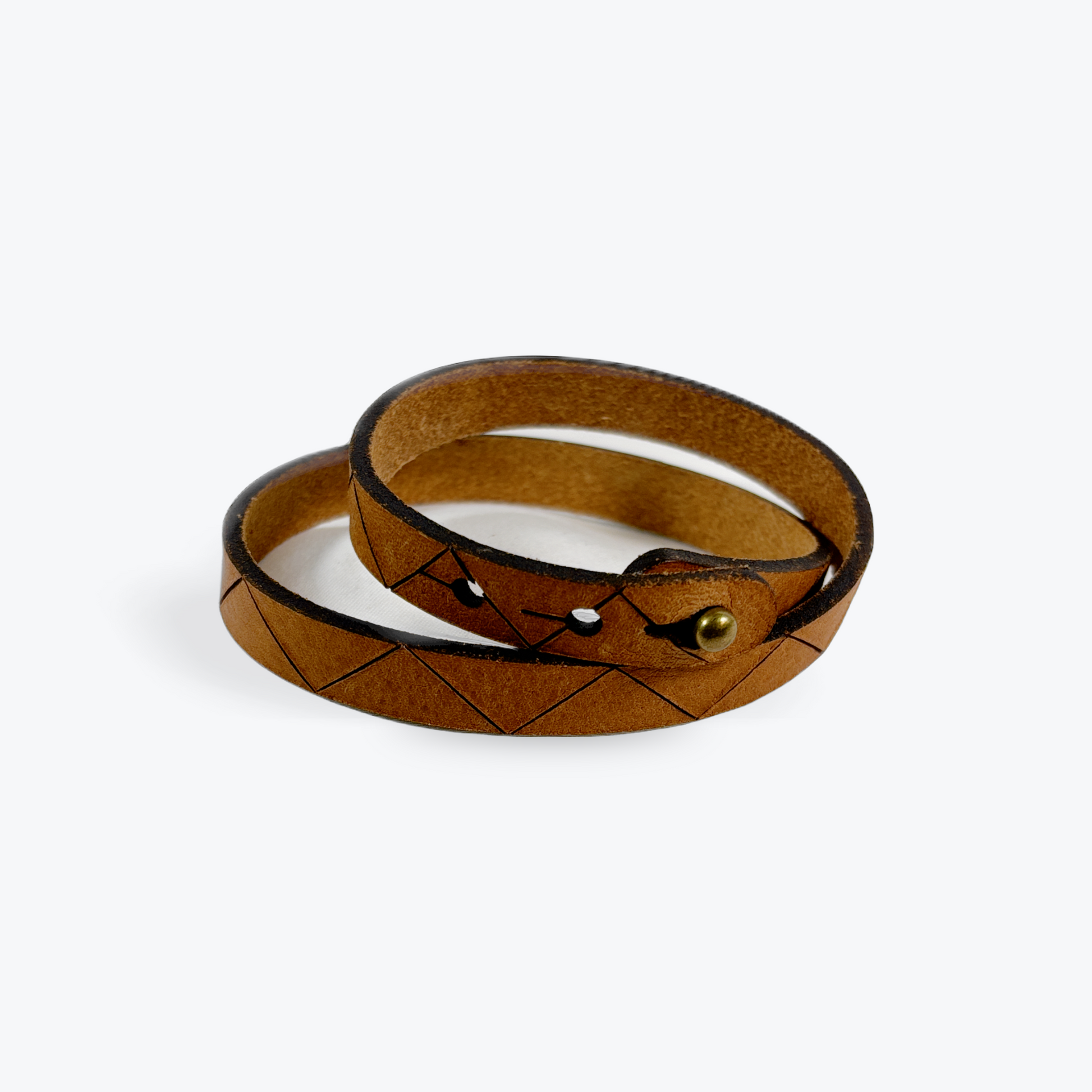 Brown leather bracelet with a gold clasp on a white background