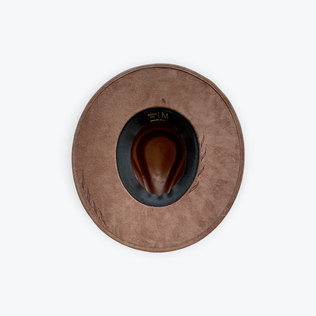 A top-down view of a brown wide-brim hat with a suede-like texture, a dark navy inner band, and a brown cowboy-style hat insert in the center, set against a plain white background.