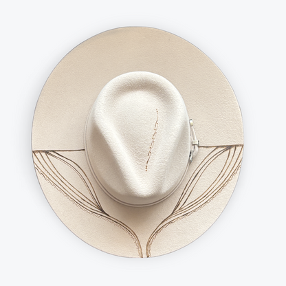 Beige hat with a decorative band on a white background