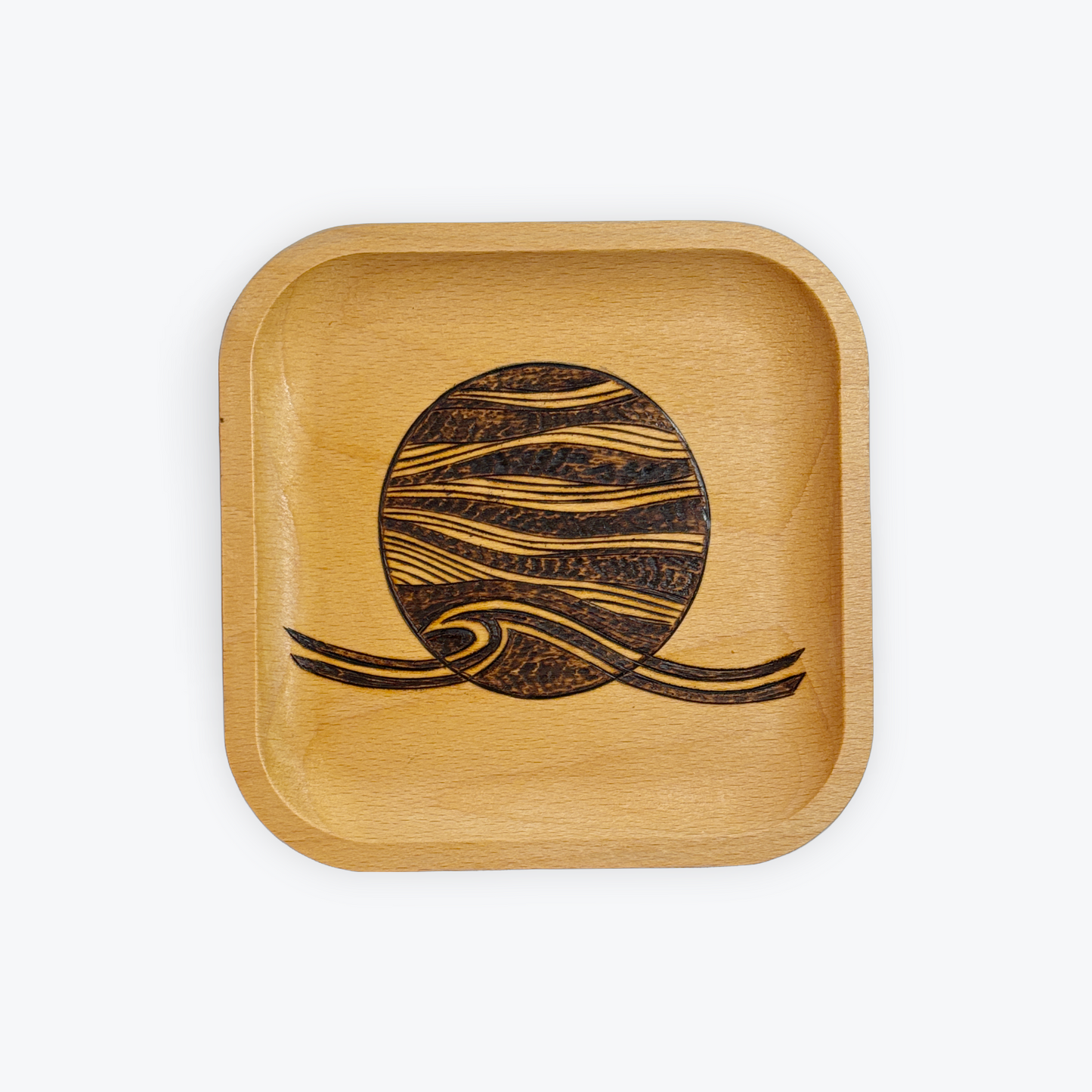 Wooden tray with a engraved design on a white background