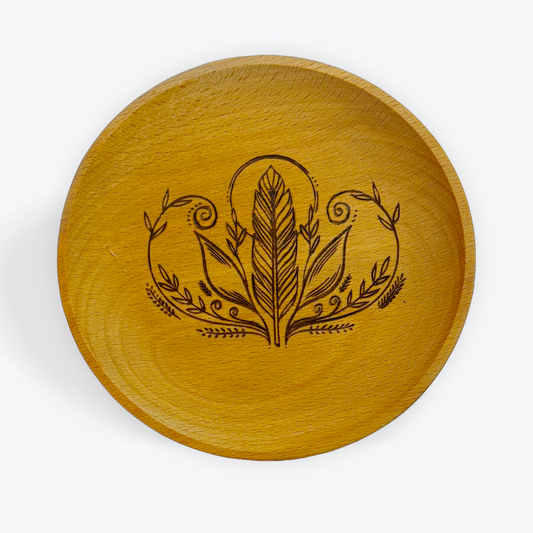 Wooden trinket tray with engraved design on a white background